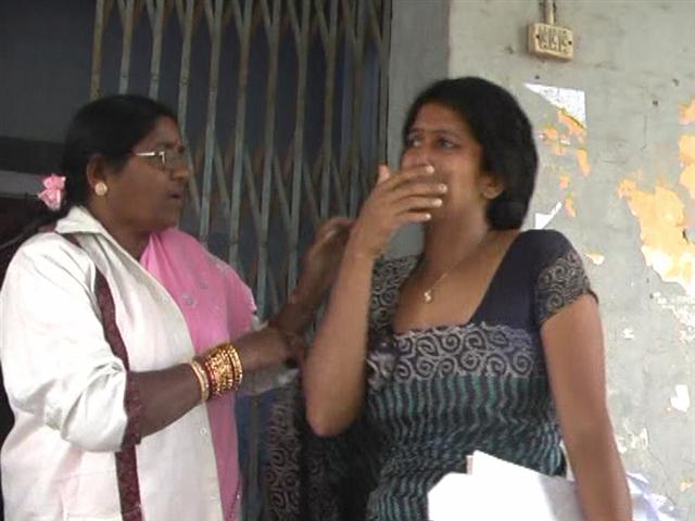 Virajpet TP President Saritha Poonacha being consoled by a member, after she left the meeting in tears.